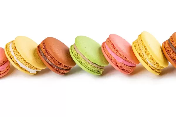 Sweet dessert background with fresh macaroons on white