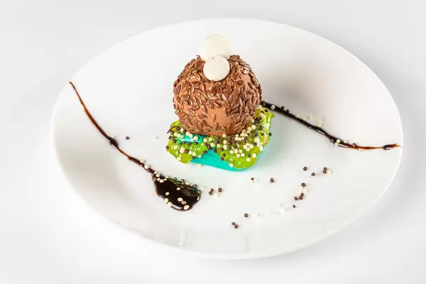 Sweet dessert with chocolate and flax seeds on a white plate