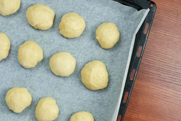 Sweet yeast dough on the oven pan