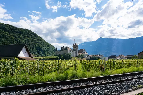 Swiss Château with vineyard fields and rail tracks in front of it
