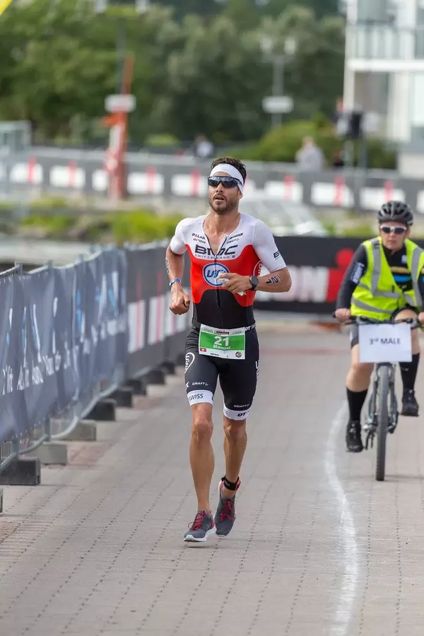 Swiss professional runner Manuel Kueng, shortly before winning a bronze medal, runs the Ironman 70.3 marathon in Lahti, Finland
