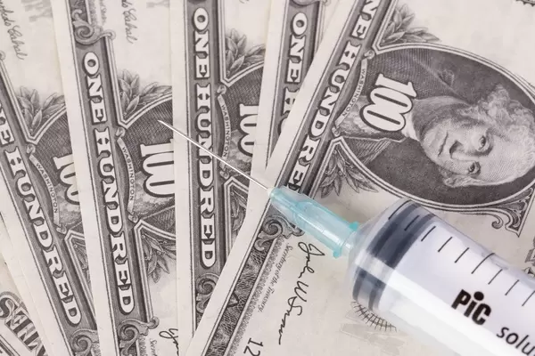 Syringe on American dollars banknotes