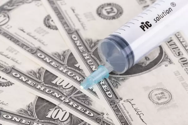 Syringe with American dollars banknotes