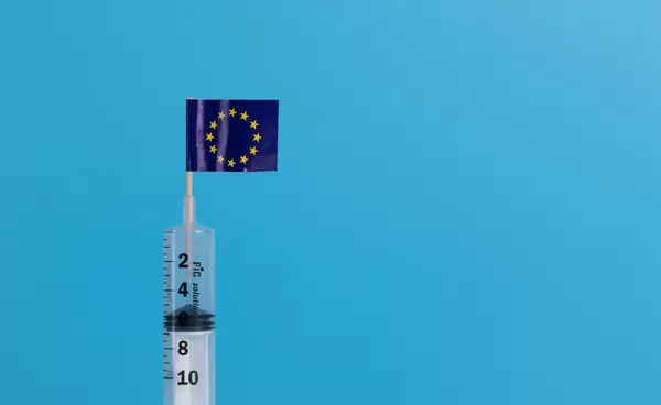 Syringe with flag of EU on blue background
