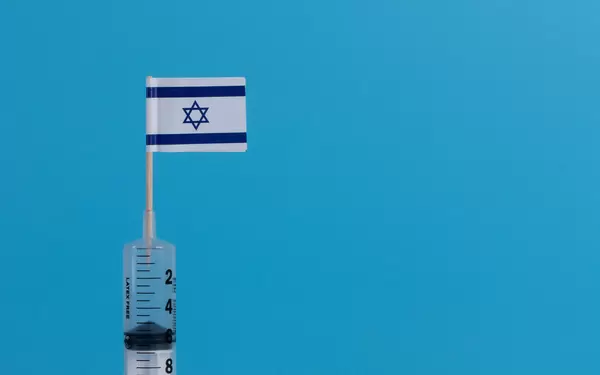 Syringe with flag of Israel on blue background