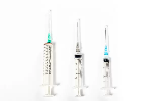 Syringes of different size on white background. Top view (Flip 2019)