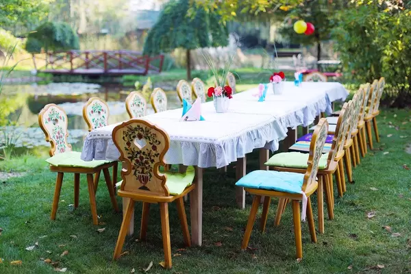 Table and chairs arranged for outdoor children party (Flip 2019)
