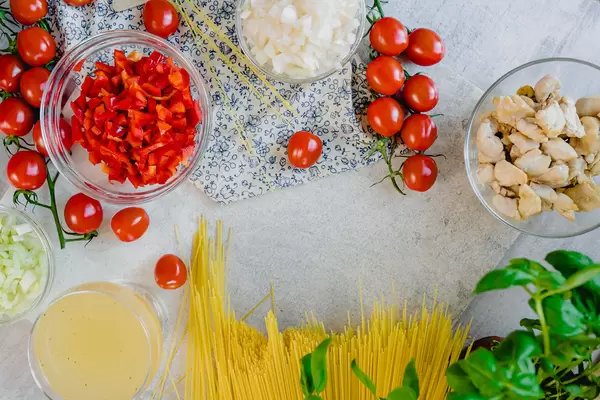 Table Flatlay Set With Chicken Spagetti Ingredients CloseUp