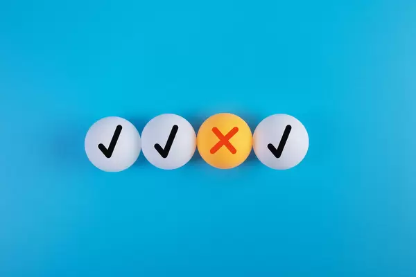 Table tennis balls with check marks and X cross