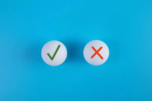 Table tennis balls with green check mark and red cross