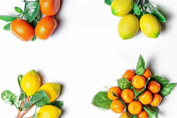 Tangerines and lemons with leaves on a white background with free space (Flip 2020)