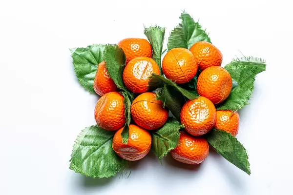 Tangerines with leaves fridge magnets on a white background