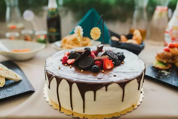 Tasty Homemade White Cake With Chocolate Glaze And Berries On Top