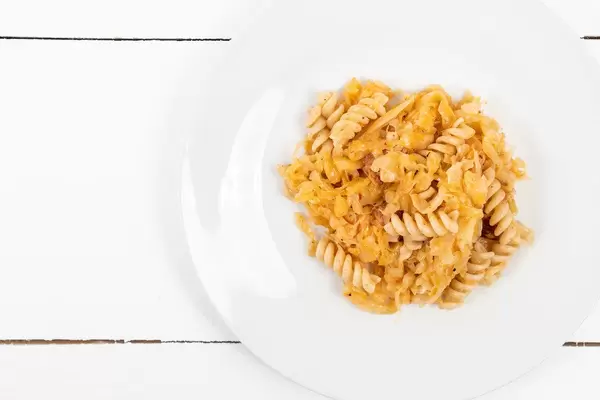 Tasty Pasta with Sauerkraut above white background