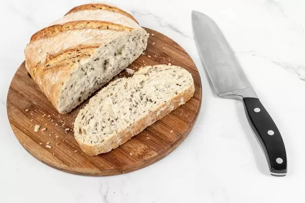 Tasty rustic bread sliced on the wooden board (Flip 2019)