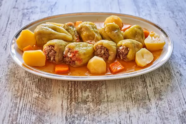 Tasty stuffed bell peppers on grey wooden table