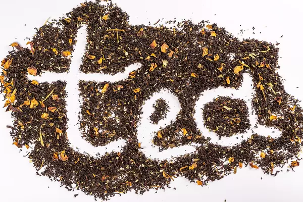 Tea inscription on the background of dried black tea