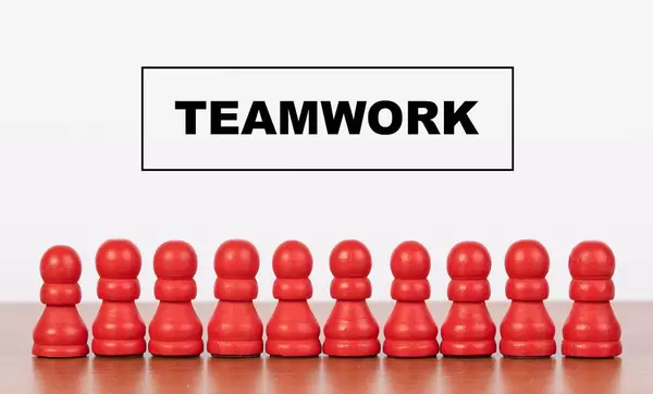 Teamwork concept with pawn figurines on table