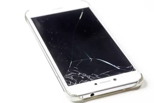 Telephone with broken screen on white background (Flip 2019)