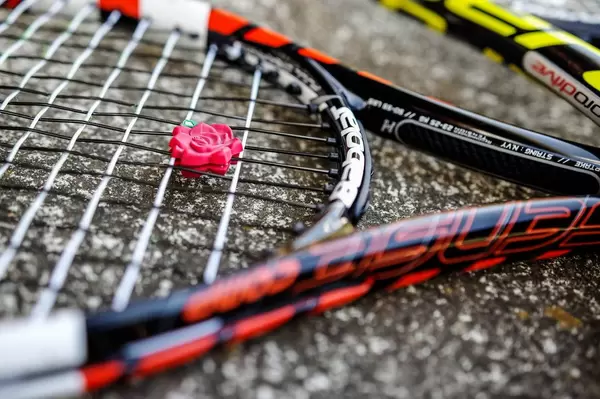 Tennis racket with a vibration dampener