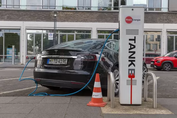 Tesla Model S at a German "RheinEnergie" charging station for electric cars in front of the Cologne public transport company KVB