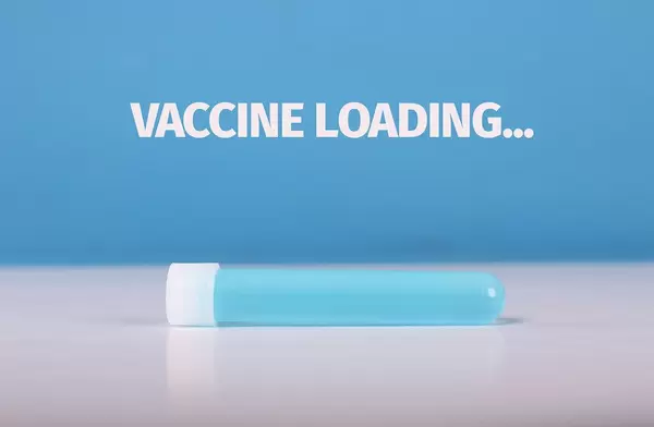Test tube with blue fluid and Vaccine loading text