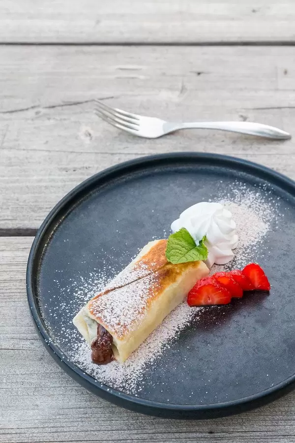 Tex-mex dessert Chimichanga in vegan version on Majorca: tortilla with chocolate and strawberries