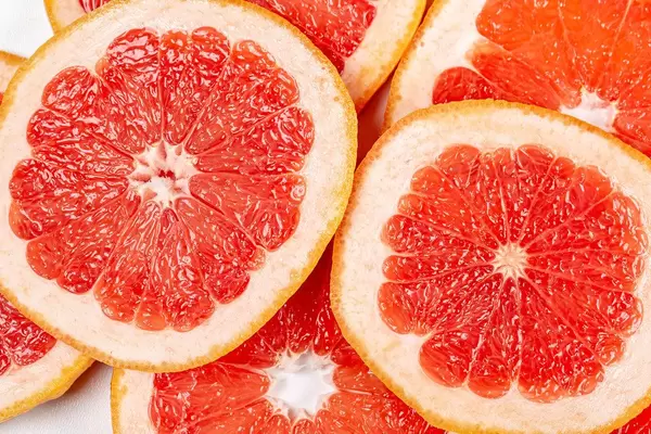 Texture of a ripe grapefruit slice, closeup