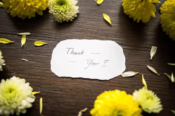 THANK YOU note among flowers