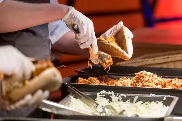 The Bavarian version of a pulled pork sandwich is prepared to be served to the visitors of the Bits & Pretzels event in Munich, Germany