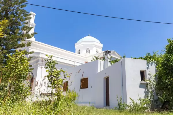 The blue dome of the white church of Panagia Protothronos against the blue sky in Halki, Naxos