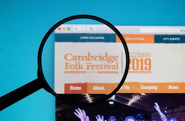 The Cambridge Folk Festival logo on a computer screen with a magnifying glass