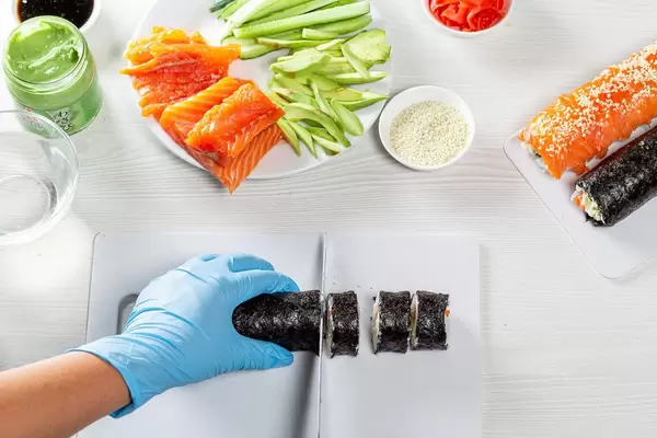 The chef cuts the roll with a knife