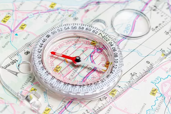 The compass lies on the map. Terrain orientation concept