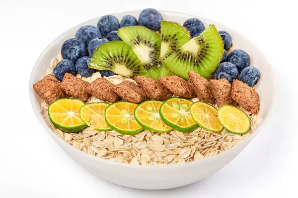 The concept of a delicious and healthy breakfast - oatmeal and fruits