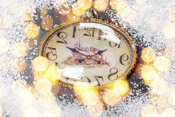 The concept of approaching the New Year. The clock on the snow and bokeh (Flip 2019)
