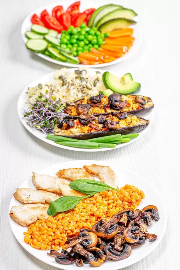 The concept of delicious healthy food. Baked eggplant with couscous, chicken with mushrooms and chickpeas and vegetable slicing