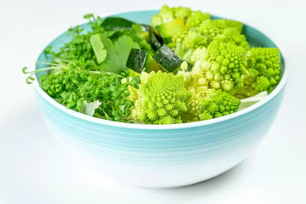 The concept of healthy diet food. Salad with avocado, romanesco cabbage and watercress (Flip 2020)