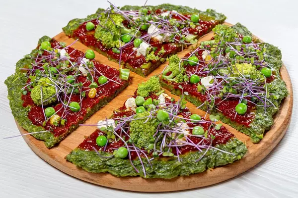 The concept of healthy food. Pizza with vegetables and micro greens cabbage (Flip 2019)