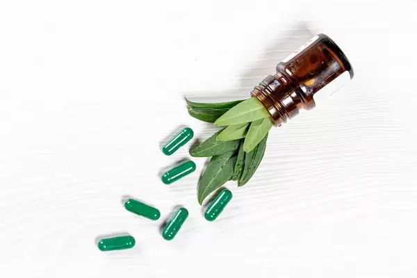 The-concept-of-herbal-medicines-Green-capsules-and-leaves-top-view.jpg