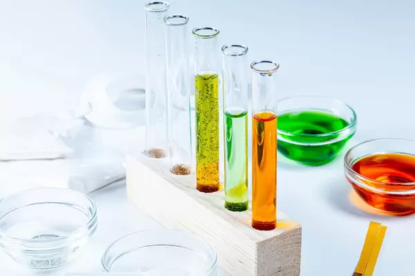 The concept of studying chemistry. Test tubes and reagents on a white background (Flip 2020)