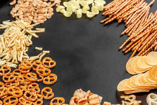 The concept of the Oktoberfest. Frame with beer snacks on black background