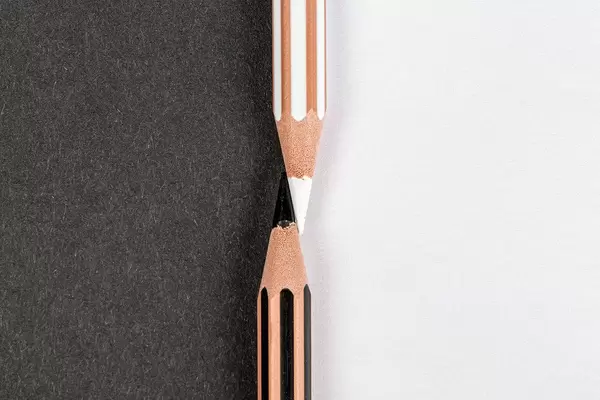 The concept of the opposite. Black and white pencils