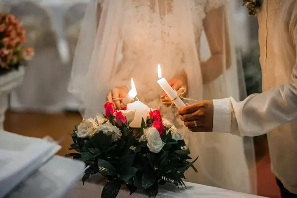 The couple lighting a unity candle at a wedding  Flip 2019