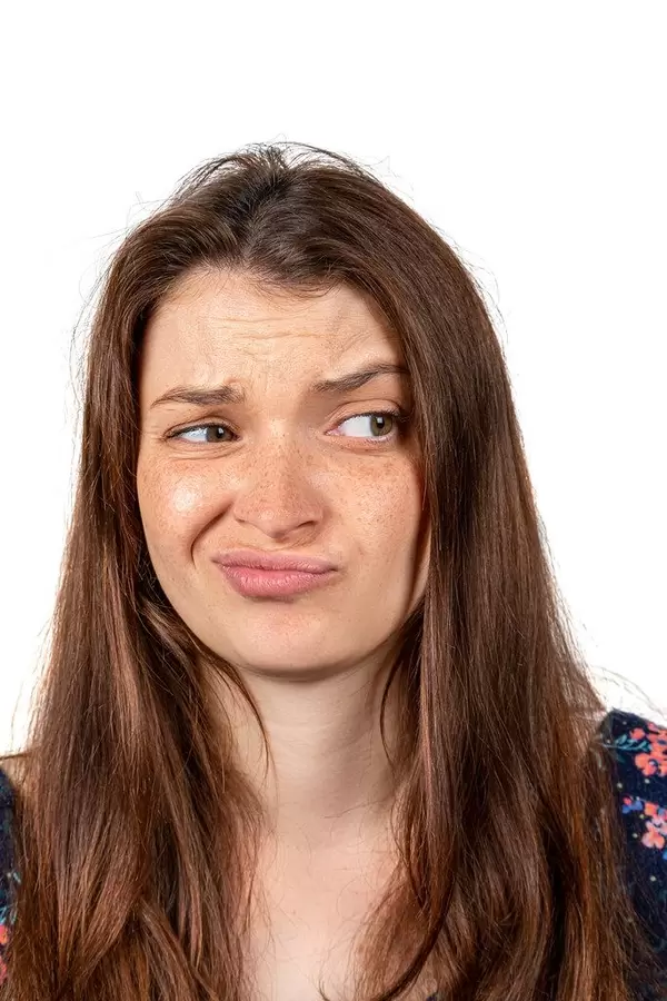 The displeased face of the girl. The concept of deceived expectations, chagrin