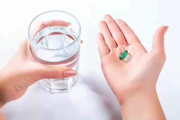 The girl is going to take the medicine