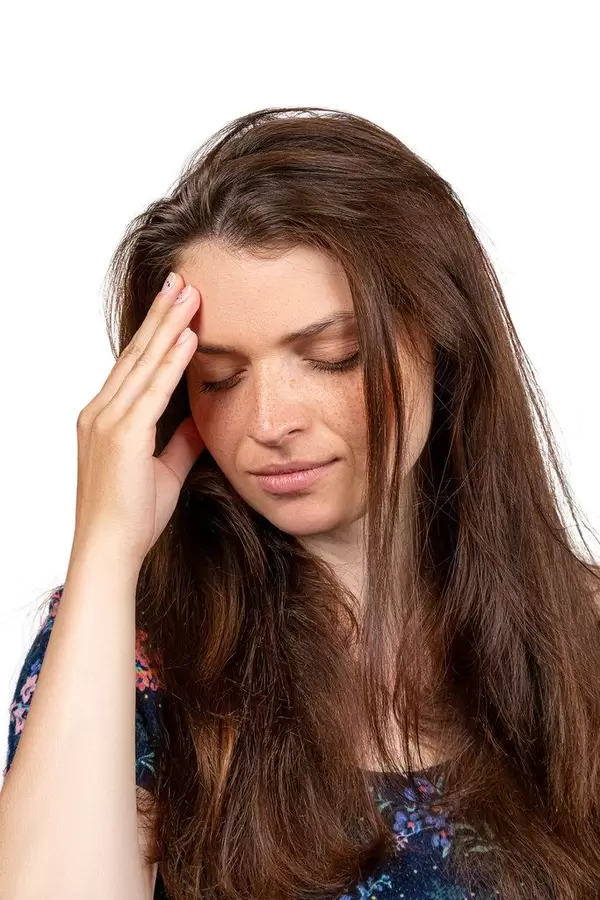 The girl with closed eyes touches her hand to her head. Headache concept