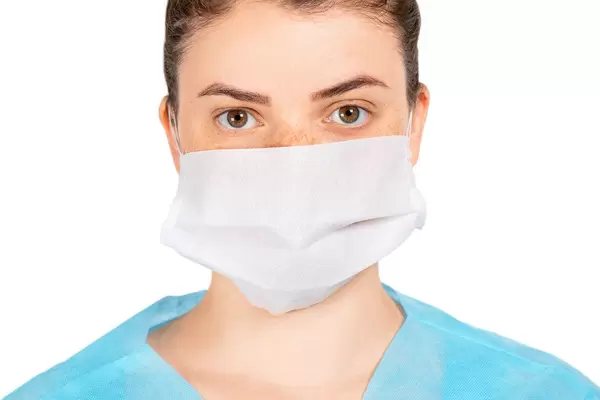 The girl's face in a protective medical mask. Disease prevention
