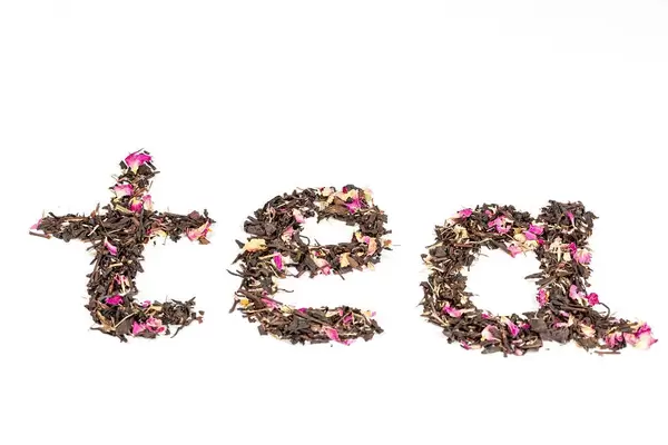 The inscription tea made from dry black tea with hibiscus petals on white