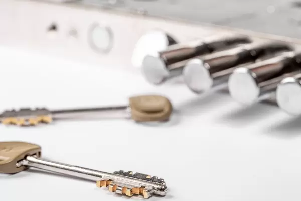 The keys and the door lock on a white background